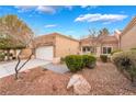 Charming single-story home with a well-maintained desert landscape and a two-car garage at 10041 Arbuckle Dr, Las Vegas, NV 89134