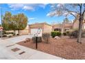 Inviting home with manicured landscaping, stone accents, and a spacious two-car garage at 10041 Arbuckle Dr, Las Vegas, NV 89134