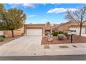 Charming single-story home with a well-manicured front yard and a two-car garage at 10041 Arbuckle Dr, Las Vegas, NV 89134