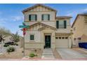 Charming two-story home showcasing desert landscaping, an attached garage, and front door seasonal decor at 10265 Franford Ct, Las Vegas, NV 89183
