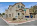 Two-story home featuring desert landscaping, an attached garage, and complementary toned stucco, shutters and trim at 10265 Franford Ct, Las Vegas, NV 89183