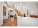 Grand foyer with a staircase, chandelier, and tile flooring at 12 Cascade Lake St, Las Vegas, NV 89148
