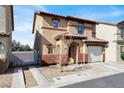 Inviting two-story home featuring a cozy front yard and a private driveway at 1203 Sweet Orange St, Las Vegas, NV 89142