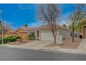 Charming single-story home with a well-manicured front yard and a two-car garage at 1404 Dragon Rock Dr, Henderson, NV 89052