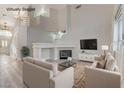 Cozy living room featuring a fireplace, plush seating, and modern decor at 1700 Wandering Winds Way, Las Vegas, NV 89128