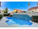 Beautiful backyard pool surrounded by lush greenery and privacy walls at 1700 Wandering Winds Way, Las Vegas, NV 89128