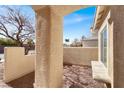 Private courtyard featuring a stylish wall with integrated seating and desert-friendly landscaping at 1831 Cavendish Way, Henderson, NV 89012