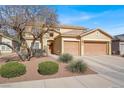 Charming two-story home boasts a well-manicured lawn and a convenient two-car garage at 1831 Cavendish Way, Henderson, NV 89012