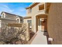 Inviting home entrance with a charming porch, stylish front door, and desert-friendly landscaping at 1831 Cavendish Way, Henderson, NV 89012