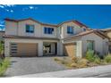 Striking two-story home with two garages, a paved driveway and desert landscaping at 195 Cactus Sunrise St, Las Vegas, NV 89138