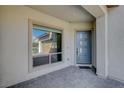 Covered front porch with a modern front door and stone paver flooring at 195 Cactus Sunrise St, Las Vegas, NV 89138