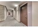 Hallway featuring unit doors, modern lighting, and neutral tones, creating an inviting and stylish entryway at 200 Hoover Ave # 1210, Las Vegas, NV 89101