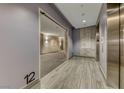 Hallway showcasing a unit entrance, elevator access, and contemporary design elements for a stylish living experience at 200 Hoover Ave # 1210, Las Vegas, NV 89101