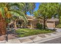 Inviting single-level home with mature landscaping, a green lawn, and a convenient two-car garage at 2020 Sinfonia Ave, Henderson, NV 89052