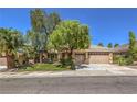 Beautiful single-story home featuring lush landscaping, mature trees, and a spacious two-car garage at 2020 Sinfonia Ave, Henderson, NV 89052