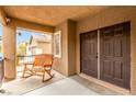 Cozy covered porch with a wooden rocking bench and a view of the neighborhood at 2199 Timescape Ct, Las Vegas, NV 89123