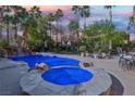 Resort-style backyard with sparkling pool, spa, waterfall feature and lush landscaping, perfect for entertaining at 2323 Carinth Way, Henderson, NV 89074