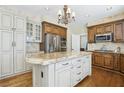 Gourmet kitchen boasts custom cabinets, stainless steel appliances, granite countertops, and center island at 2323 Carinth Way, Henderson, NV 89074