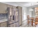 Dining area features stainless steel refrigerator and a modern light fixture and room for four at 251 S Green Valley Pkwy # 3412, Henderson, NV 89012