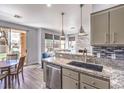 Bright kitchen features an island with granite counters, stainless appliances, and adjacent dining area at 251 S Green Valley Pkwy # 3412, Henderson, NV 89012