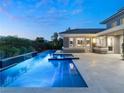 Stunning backyard pool and spa area with sleek design and lush landscaping, creating a private retreat at 2623 Turtle Head Peak Dr, Las Vegas, NV 89135