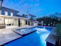 Beautiful pool and spa with ample patio space, complemented by mature trees and a serene ambiance at 2623 Turtle Head Peak Dr, Las Vegas, NV 89135