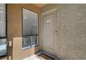 Apartment entrance featuring a welcome mat, textured wall and exterior window at 3151 Soaring Gulls Dr # 1010, Las Vegas, NV 89128