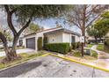 Home exterior showing driveway with tidy landscaping and mature trees at 3440 Pino Cir, Las Vegas, NV 89121