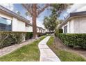 Exterior of the home with a walking path and green shrubbery at 3440 Pino Cir, Las Vegas, NV 89121