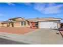 Cozy home with front yard featuring desert landscaping and a 2-car garage at 3610 El Camino Rd, Las Vegas, NV 89103