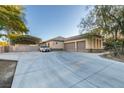 Spacious driveway leading to a three-car garage and gated carport at 3801 W Hammer Ln, North Las Vegas, NV 89031