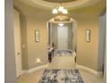 Inviting entryway with neutral tones, tiled flooring, art and an arched ceiling, giving a warm welcome at 4242 Helena Hideaway Ct, Las Vegas, NV 89129