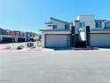 Contemporary home featuring a two-car garage and modern architectural details on a sunny day at 483 Fairview Hills St, Las Vegas, NV 89138