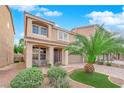 Inviting two-story home with desert landscaping, a charming front porch, and a spacious two-car garage at 6435 Parrot Ridge Ct, Las Vegas, NV 89139