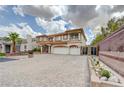 Attractive two-story home featuring a three-car garage and desert landscaping at 6491 Bright Nimbus Ave, Las Vegas, NV 89139