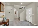 Bright entryway featuring tile flooring, a staircase, and an inviting atmosphere at 7476 Moonglade St, North Las Vegas, NV 89084