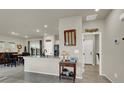 Open concept kitchen featuring granite counters, tile floors, and stainless steel appliances at 7476 Moonglade St, North Las Vegas, NV 89084
