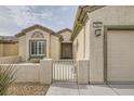 Inviting entrance to a single-story home with secure gate, and bench at 7567 Wingspread St, North Las Vegas, NV 89084