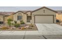 Inviting single-story home with manicured xeriscaped front yard and a convenient two-car garage at 7567 Wingspread St, North Las Vegas, NV 89084
