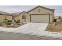 Single-story home featuring a xeriscaped front yard, complemented by a two-car garage at 7567 Wingspread St, North Las Vegas, NV 89084