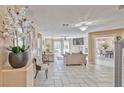 Open-concept living area with tile floors, contemporary furnishings, and bright natural light at 7581 Slipstream St, Las Vegas, NV 89139