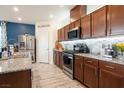 Modern kitchen featuring stainless steel appliances, granite countertops, and custom cabinetry at 8432 Alder Rain St, Las Vegas, NV 89113