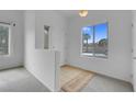 Well-lit entryway with neutral carpet, tiled landing, and view to the outside at 8805 Jeffreys St # 2082, Las Vegas, NV 89123