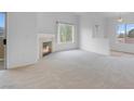 Spacious living room with a cozy fireplace and sliding glass doors leading to outdoor space at 8805 Jeffreys St # 2082, Las Vegas, NV 89123