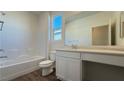Bathroom features a tub-shower combination, white vanity, and vinyl flooring at 9067 Mapledale Ranch Ct, Las Vegas, NV 89139