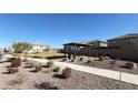 Community park space featuring a covered seating area, walking path, and low-maintenance landscaping at 9189 Oakdale Ranch Ct, Las Vegas, NV 89139