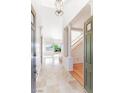Bright foyer with high ceilings, tile flooring, decorative columns and staircase leading to the second floor at 10227 Sunset Gardens Dr, Las Vegas, NV 89135