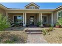 Inviting front porch with decorative plants and shade, leading to the home's entrance at 11181 Luna Blanca Dr, Las Vegas, NV 89138