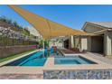 Gorgeous backyard with a sparkling pool and spa, perfect for enjoying warm sunny days at 11181 Luna Blanca Dr, Las Vegas, NV 89138