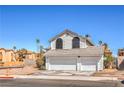 Charming two-story home featuring a three-car garage and well-maintained front yard at 1209 Shifting Sands Dr, Las Vegas, NV 89108